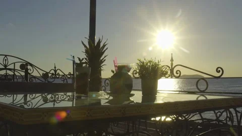 Multiple drinks on a table with sun setting in the background Stock Footage 140055380