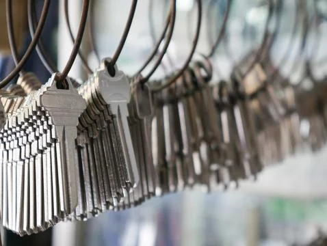 Multiple Duplicate Keys Hanging on Wire Rings at Locksmith Shop - Key Cutti.. Stock Photos