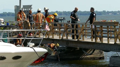 Multiple emergency team member working at the harbor searching for a flooded Video stock 94863497