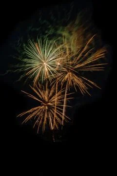 Multiple exploding fireworks in the evening sky. Stock Photos