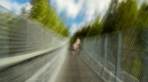 Multiple exposure and motion blur while walking across a suspension pedestrian Stock Photos