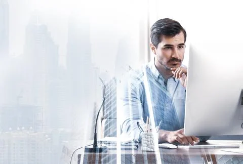 Multiple exposure of architect working with computer at table and buildings Foto stock
