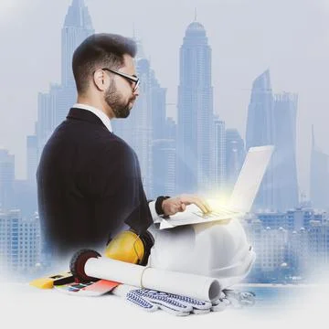 Multiple exposure of architect working with laptop and buildings Fotos de archivo