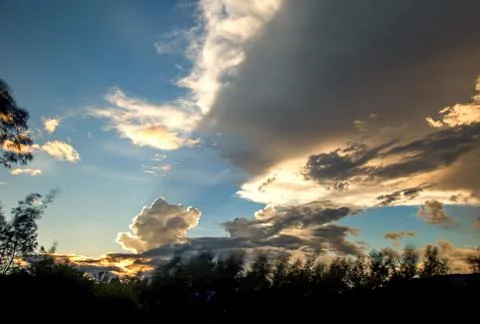 Multiple exposure of a dense cloud at the horizon casting an awesome shadow o Stock Photos