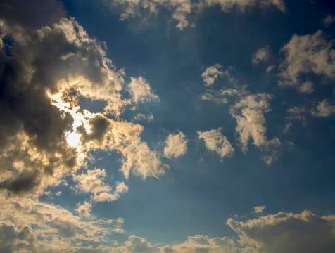 Multiple exposure of dense gray clouds hiding the sun in the afternoon. Captu Stock Photos