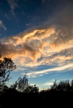 Multiple exposure of a group of yellow clouds that seems to melt with the sun Stock Photos