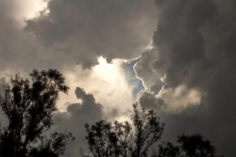 Multiple exposure of an opening in the overcasted sky wich allows the sun to  Stock-Fotos