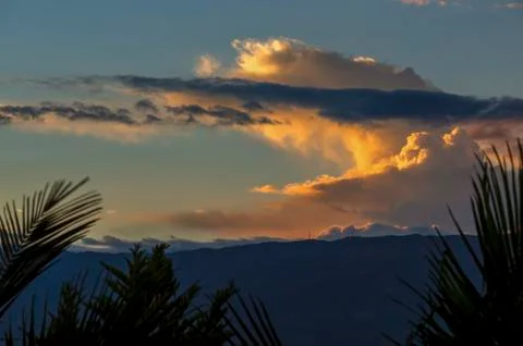 Multiple exposure of some orange and yellow clouds in a sunset over the Andea Foto stock