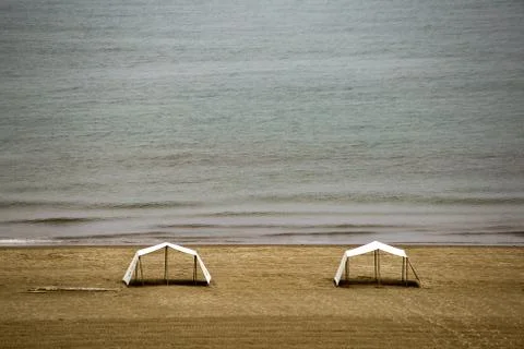 Multiple exposure of two tents standing on a deserted Caribbean beach, very e Stock Photos