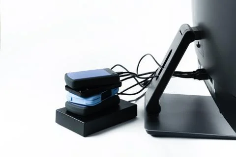 Multiple external hard drives connected to a monoblock on a white background Foto stock
