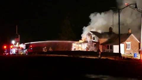Multiple Fire Crews Tackling Large House Fire At Night With Smoke Rising Stock Footage 248752935