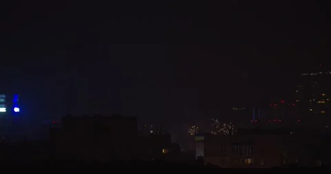 Multiple fireworks blowing up above the city building in a celebration, 4k Stock Footage 150523848