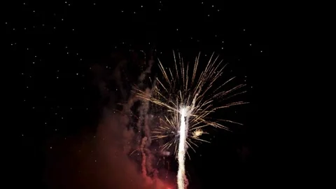 Multiple fireworks bursts illuminate the dark black night sky Stock Footage 329673993