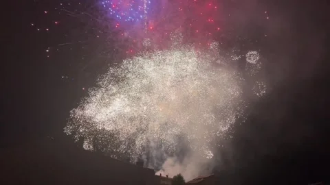 Multiple fireworks exploding with bright colors and thick smoke during a ni.. 스톡 동영상 325676545