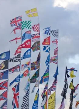 Multiple flags on poles at a carnival Stock Photos