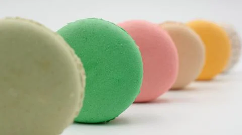 Multiple flavor Cake macaron or macaroon on turquoise macros on a white backg Stock Photos