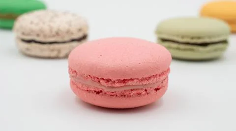 Multiple flavor Cake macaron or macaroon on turquoise macros on a white backg Stock-Fotos