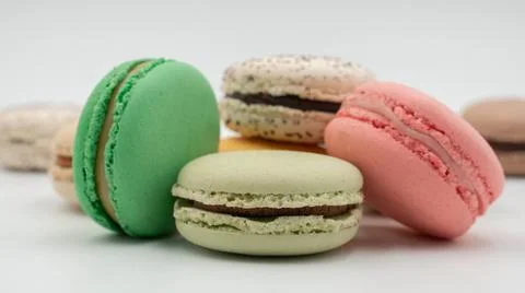 Multiple flavor Cake macaron or macaroon on turquoise macros on a white backg Stock Photos
