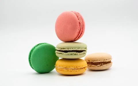 Multiple flavor Cake macaron or macaroon on turquoise macros on a white backg 写真素材