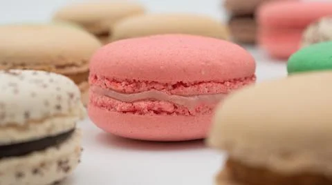 Multiple flavor Cake macaron or macaroon on turquoise macros on a white backg Photos