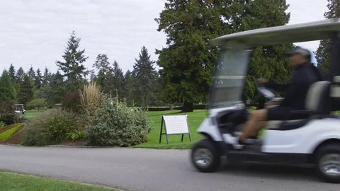 Multiple golf carts driving by camera in sequence Stock Footage 85168238