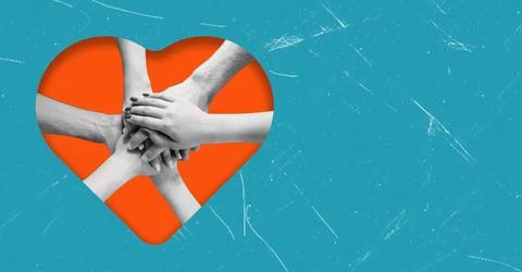 Multiple hands stack together above an orange heart shape, symbolizing collab Stock Photos