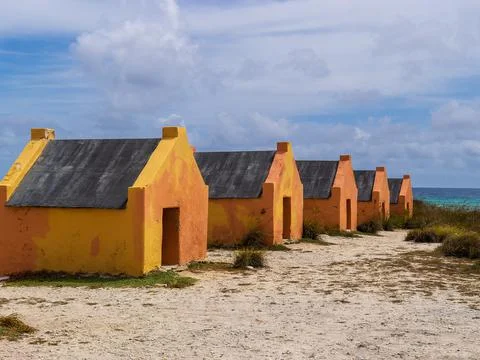 Multiple historic red slave hut sin Bonaire, Caribbean Stock Photos