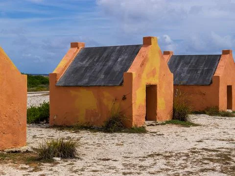 Multiple historic red slave hut sin Bonaire, Caribbean Stock Photos
