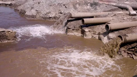 Multiple Industrial Pipes Discharging Dirty Water Into Settling Pond, Water.. Stock Footage 339148035