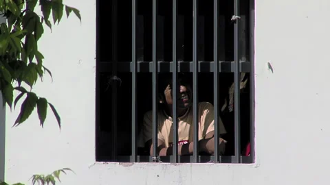 Multiple Inmates at Window of a Prison Cell, Olmos, Buenos Aires, Argentina - 4K Stock Footage 332243089