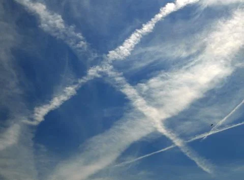 Multiple jet streams of airplane on blue sky Stock Photos