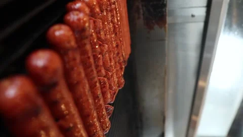 Multiple juicy and crispy hotdog sausages in line on grill grate, vertical Stock Footage 270163570