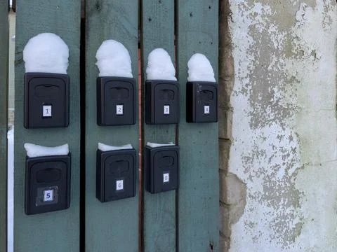 Multiple key lock boxes on rental apartment wall in winter Stock Photos