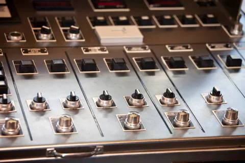 Multiple knobs and switches on panel 스톡 사진