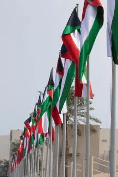 Multiple Kuwait national flags flying during the day at a event in Qatar Stock Photos
