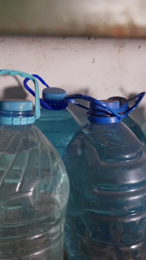 Multiple Large Plastic Water Bottles Standing Together in Storage Room Stock Footage 335646861