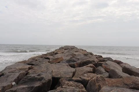 Multiple Large Rocks in the Sea with Calm Water Stock Photos