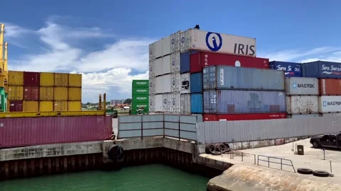 Multiple layers of large shipping containers are stacked, set against the Stock Footage 251843166
