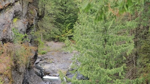 Multiple layers of waterfalls rush down mountain side Stock Footage 100559953