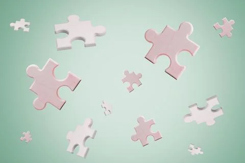 Multiple light pink and white wooden puzzle pieces floating on a green backgr Stock Photos