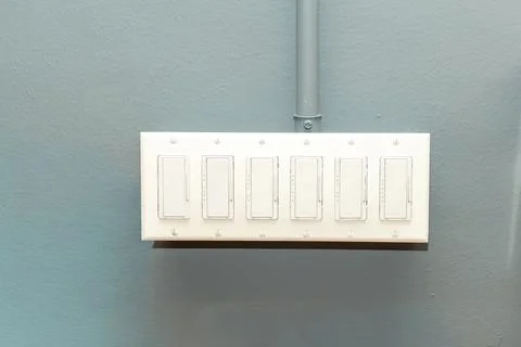 Multiple light switches in one panel, office lighting control Stock Photos