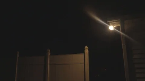 Multiple Lightning Strikes that Light up the Sky Behind a White Privacy Fence Stock Footage 95028427