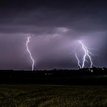 Multiple lightning strikes lighting up the sky on a summer evening during a.. Stock Photos