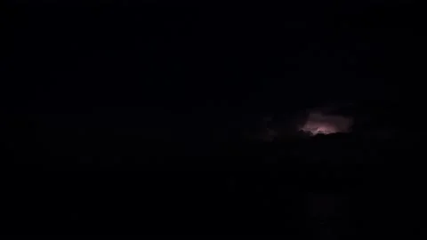 Multiple lightnings are blinking in the night sky far on the horizon, 4k Stock Footage 138141376