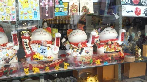 Multiple of Maneki Neko cats are sitting and waving paws. Video stock 105385069