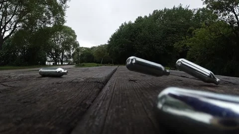 Multiple metallic nitrous oxide gas cylinder recreational drug slow motion Stock Footage 133458237