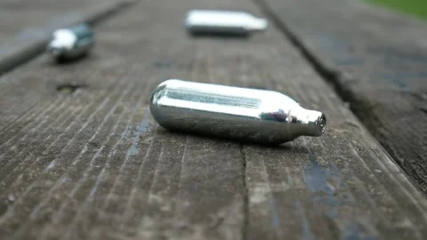 Multiple metallic nitrous oxide gas cylinder recreational drug slow motion Stock Footage 133458238