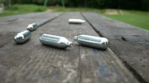 Multiple metallic nitrous oxide gas cylinder recreational drug slow motion Stock Footage 133458347