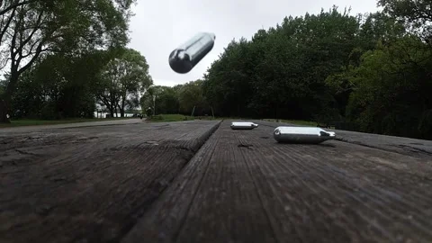 Multiple metallic nitrous oxide gas cylinder recreational drug slow motion Stock Footage 133458400