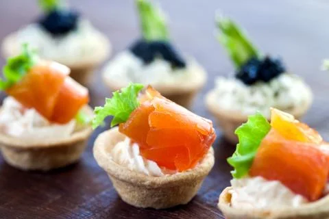 Multiple mini seafood pastry tartlets. Stock Photos